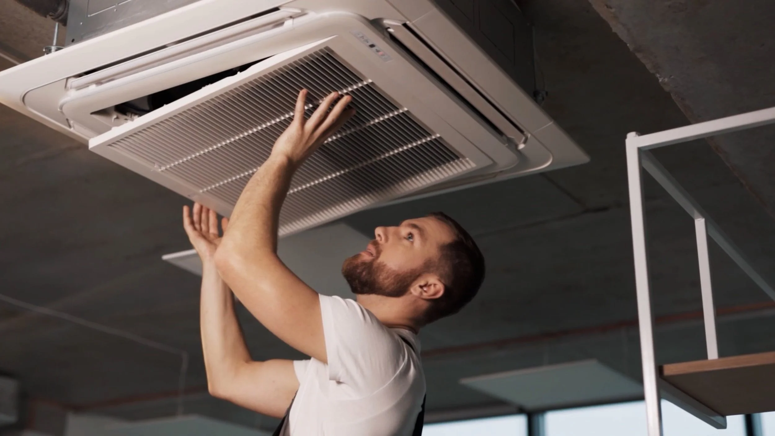 Air Duct Dynasty technician opening a vent cover to inspect the ductwork behind it