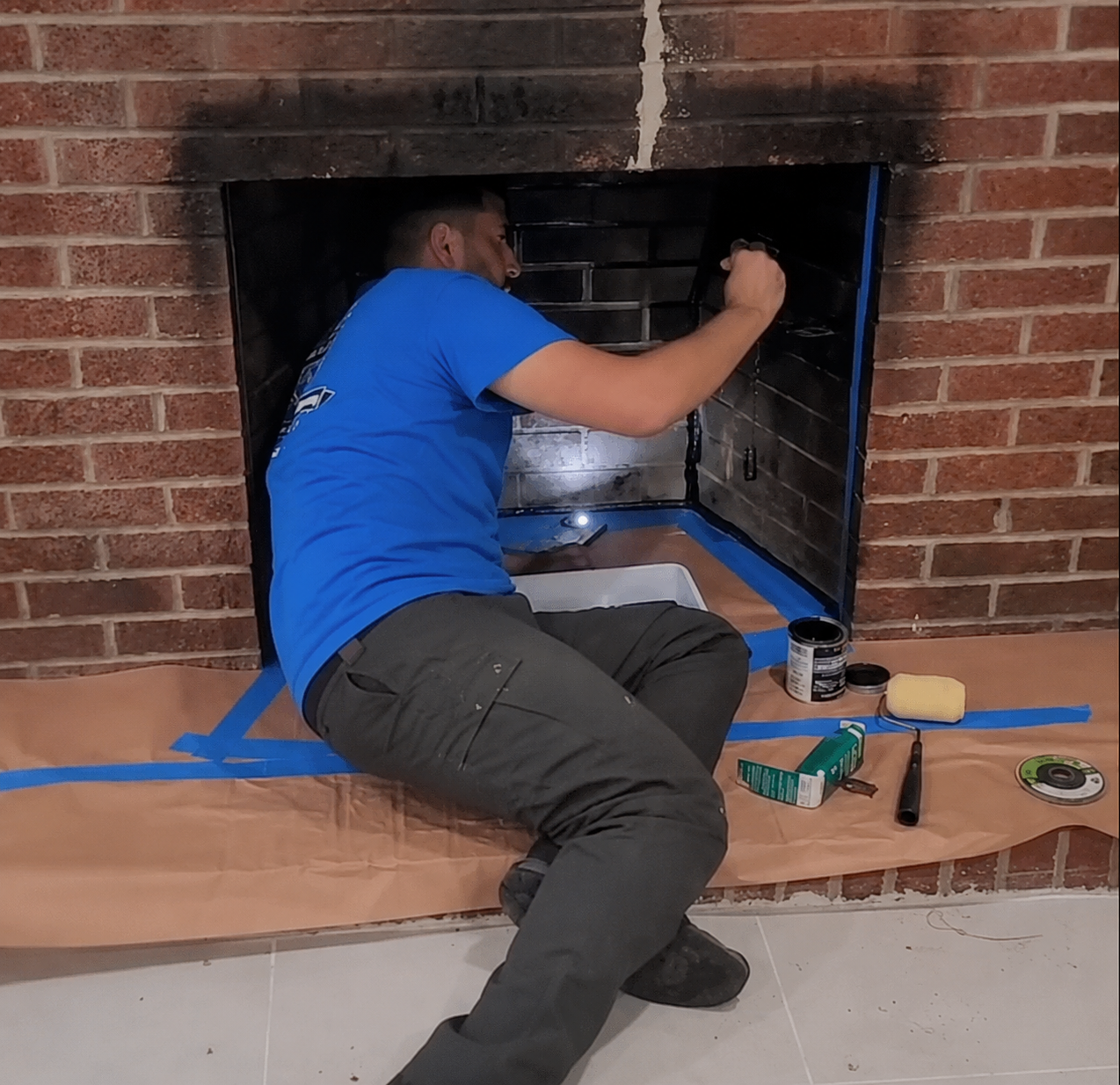 Air Duct Dynasty technician inspecting the inside of a fireplace firebox in a Philadelphia home