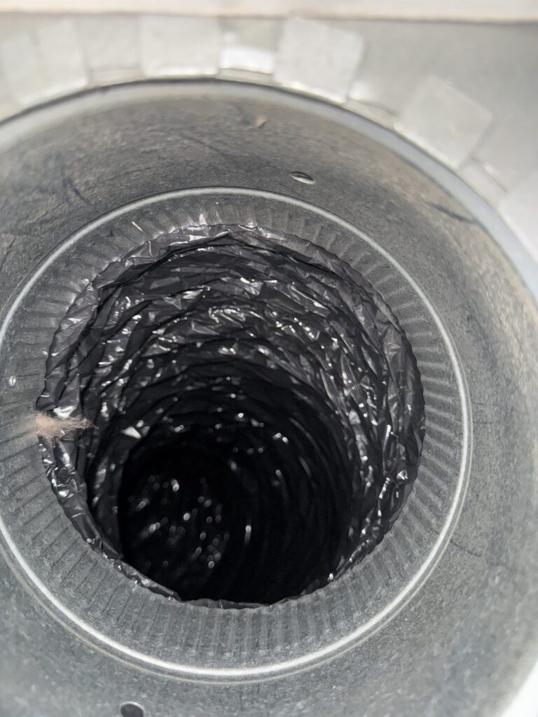 The same flexible air duct after professional cleaning, with bare metal walls and no dust buildup