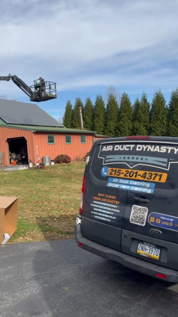 Rear of a branded Air Duct Dynasty service van on a job site