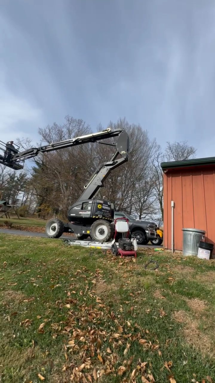 Boom lift set up on a lawn for chimney work