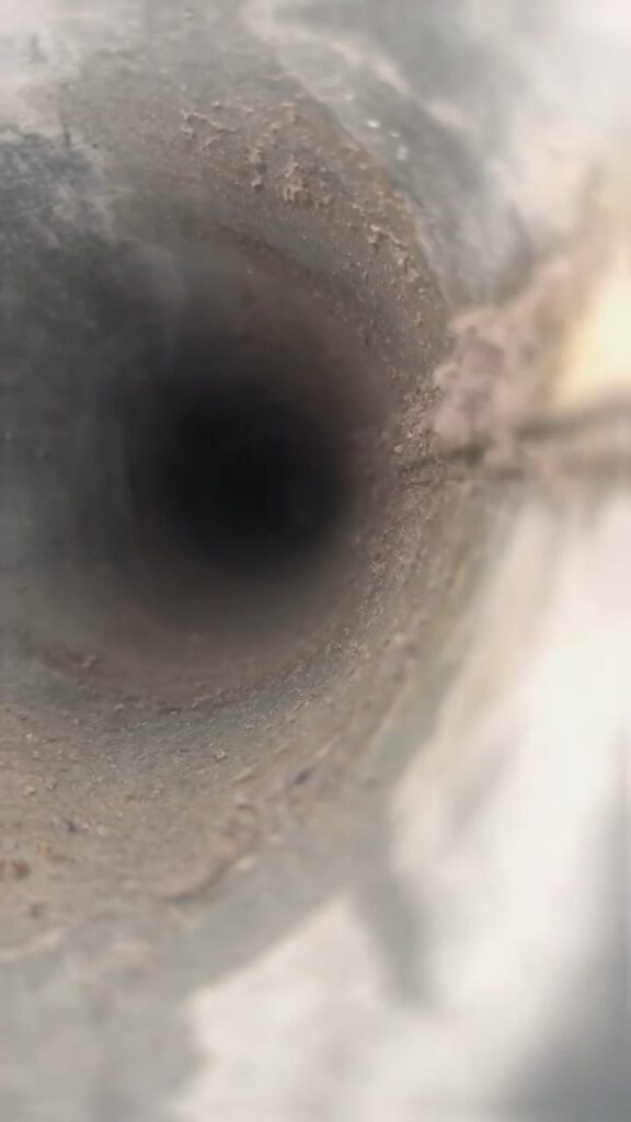 Interior of a dryer vent duct showing lint accumulation